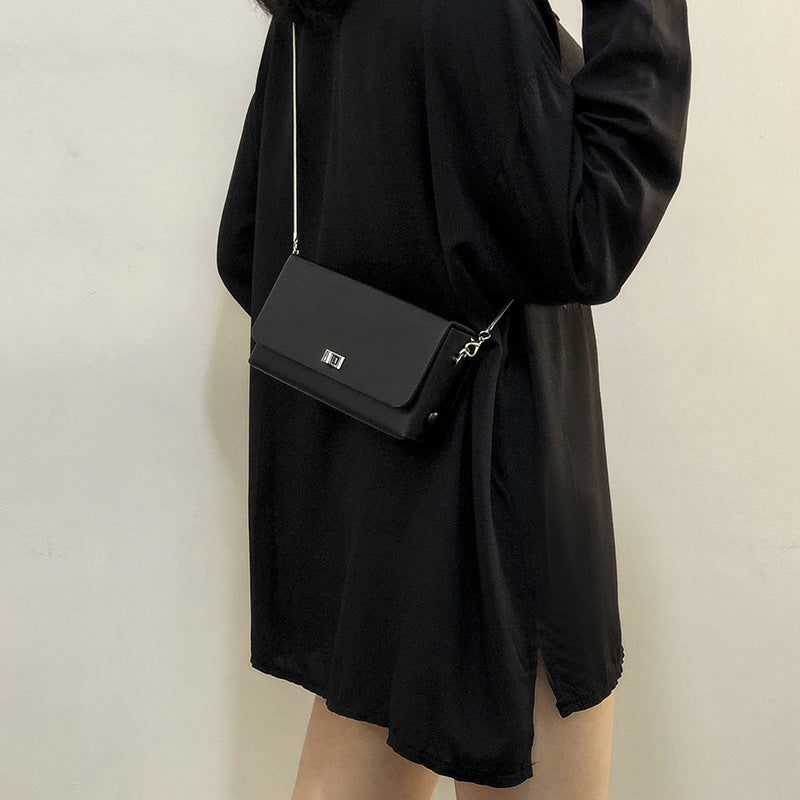 Women's clutch bag with elegant flap closure and innovative design