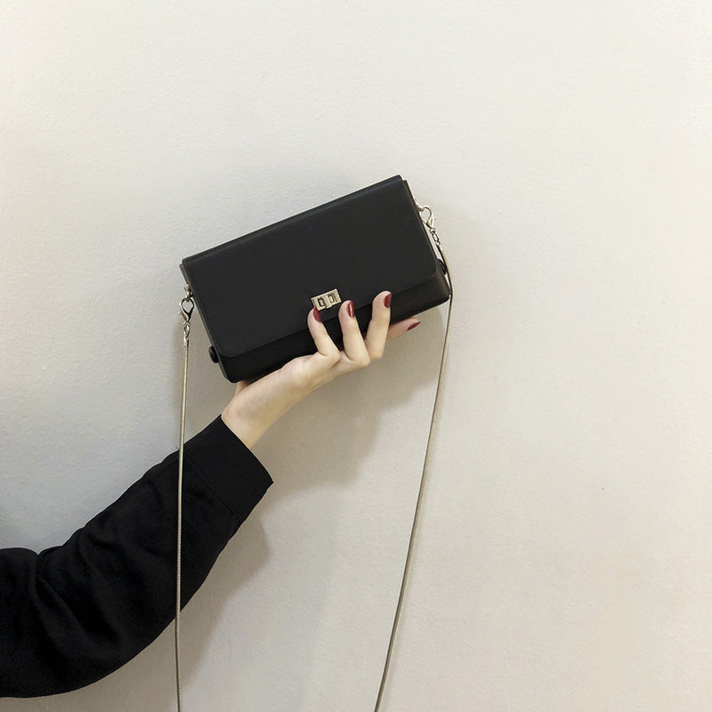 Women's clutch bag with elegant flap closure and innovative design