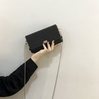 Women's clutch bag with elegant flap closure and innovative design