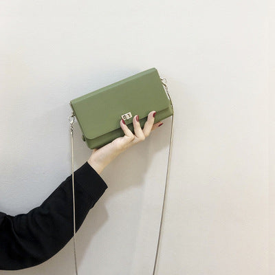 Women's clutch bag with elegant flap closure and innovative design