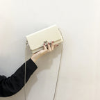 Women's clutch bag with elegant flap closure and innovative design