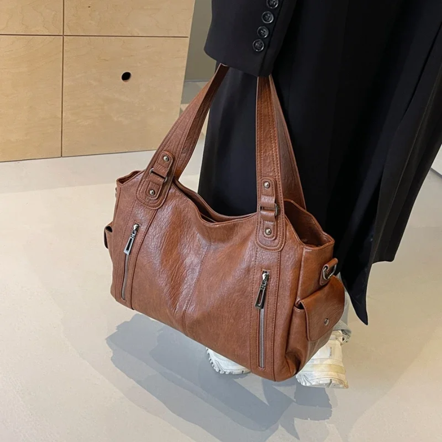 Casual shoulder bag with zippers and adjustable strap