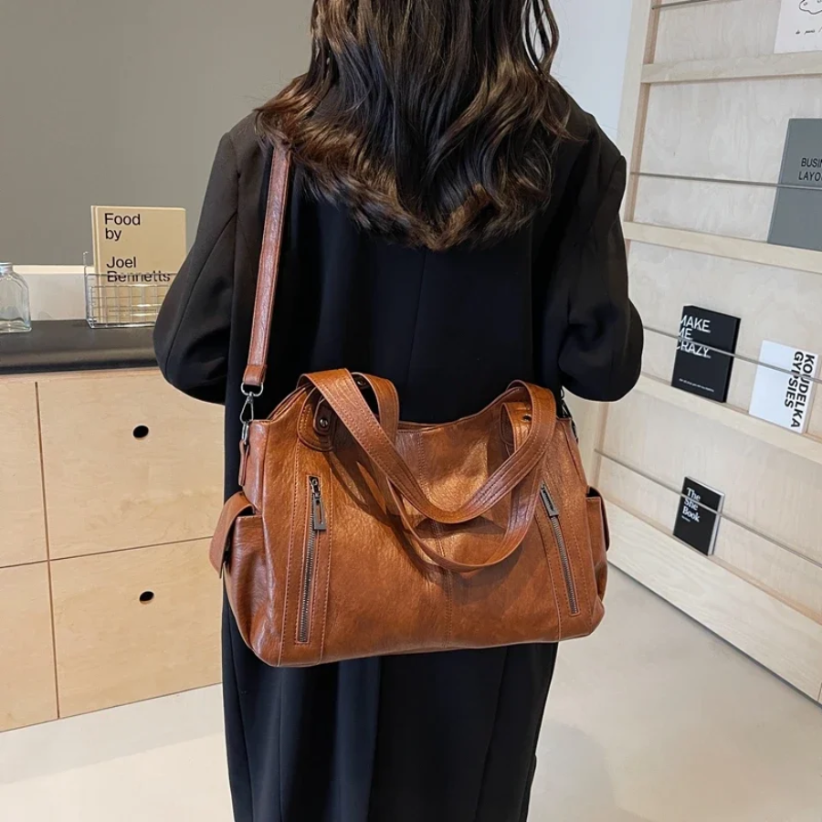 Casual shoulder bag with zippers and adjustable strap