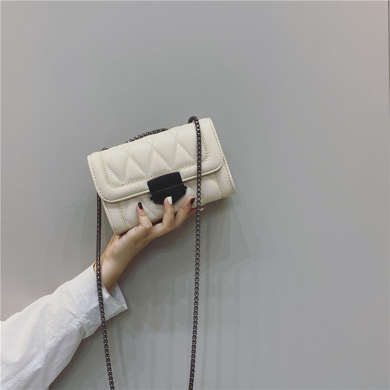 Women's clutch with stylish quilted design and detachable chain strap