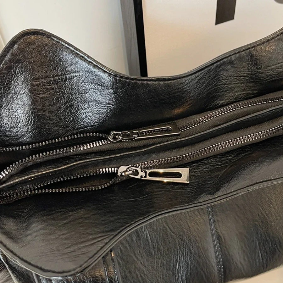 Casual shoulder bag with zippers and adjustable strap