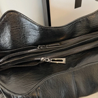 Casual shoulder bag with zippers and adjustable strap