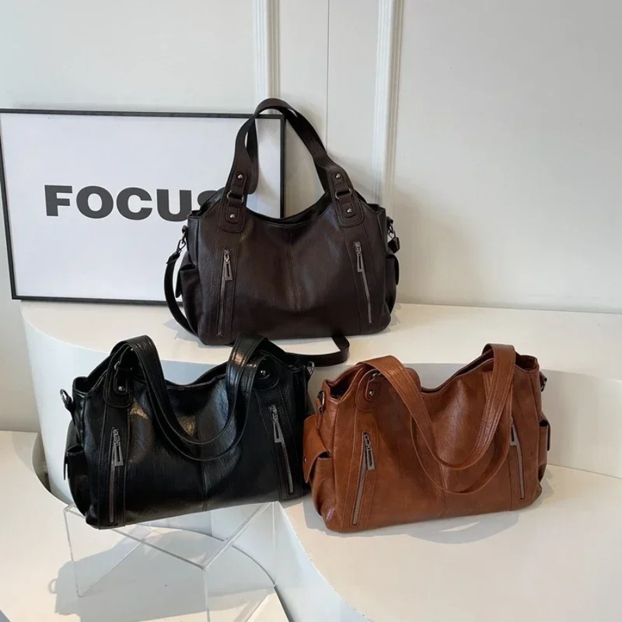 Casual shoulder bag with zippers and adjustable strap
