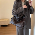 Casual shoulder bag with zippers and adjustable strap