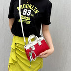 Women's mini handbag with playful pendant and elegant design