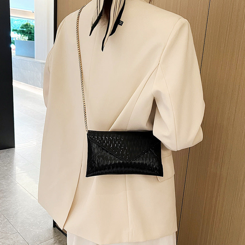 Women's elegant clutch with shiny upper material