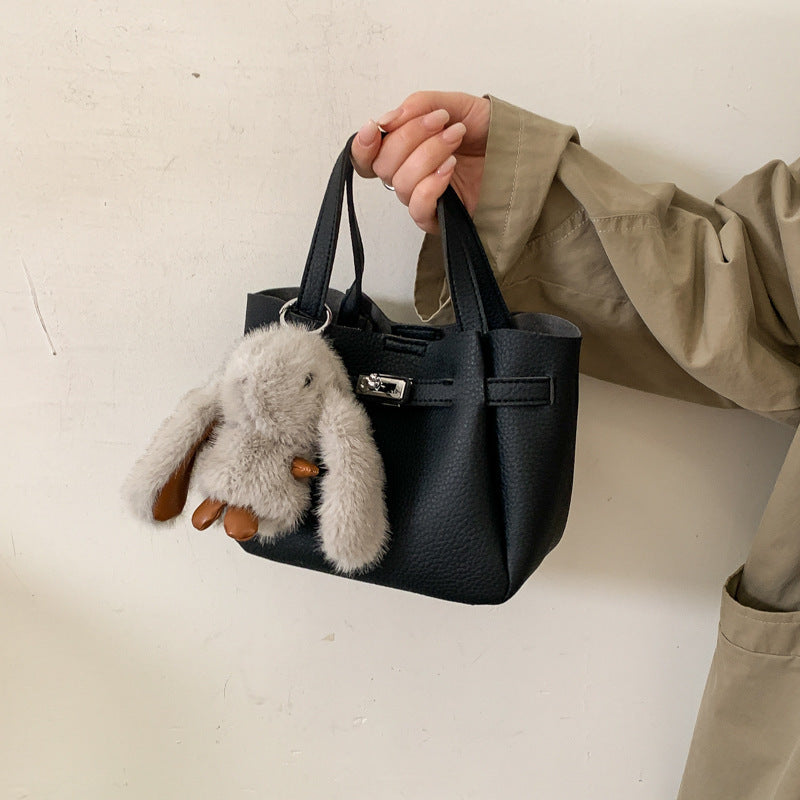 Women's mini handbag with playful design and animal charm