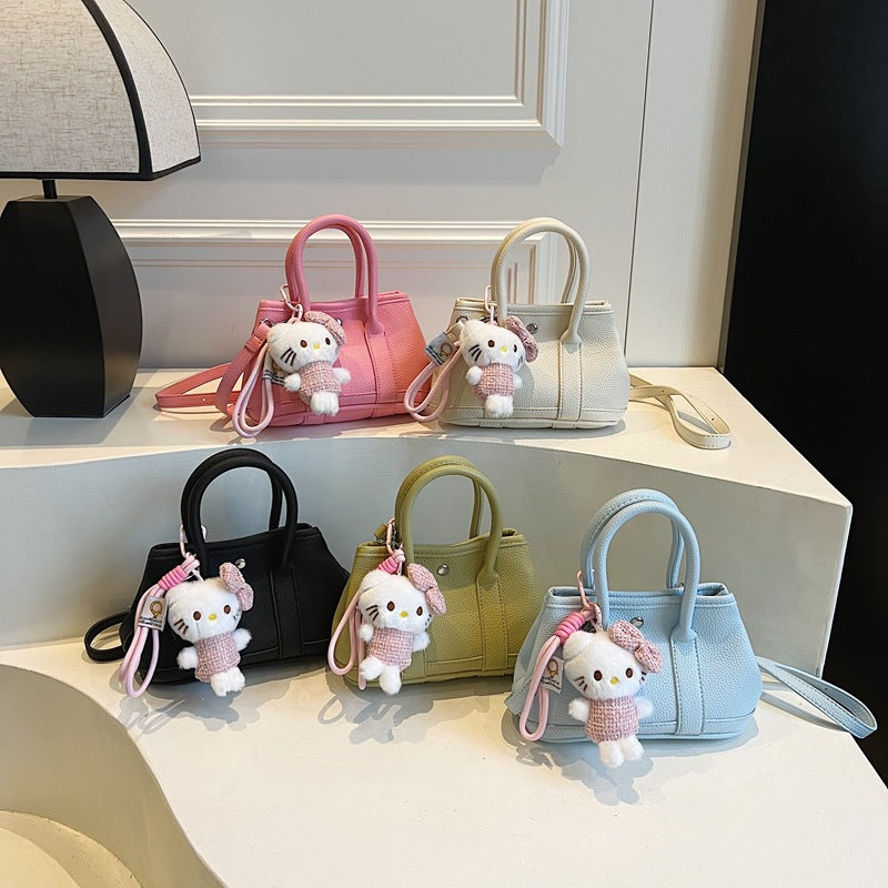 Women’s mini handbag with playful plush pendant