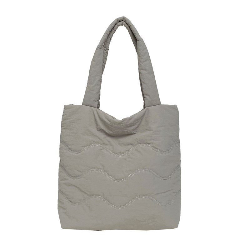 Padded shoulder bag with wave design