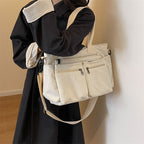 Durable shoulder bag with multiple compartments