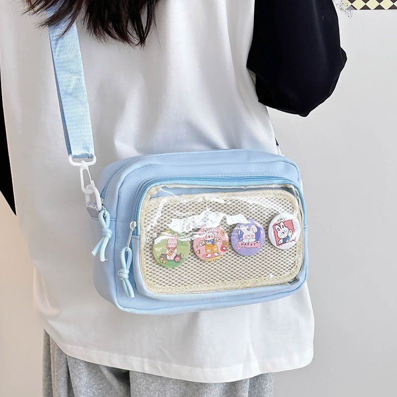 Shoulder bag with transparent viewing pocket and playful graphic design