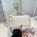 Women's mini handbag with sparkling upper material and golden studs