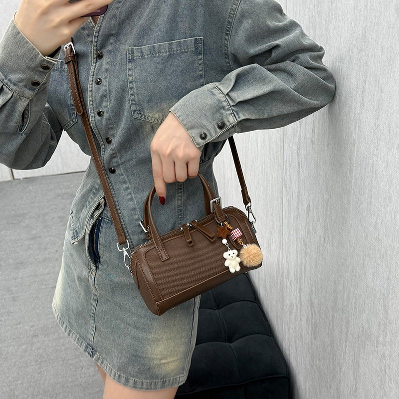 Women's mini bag with playful charm