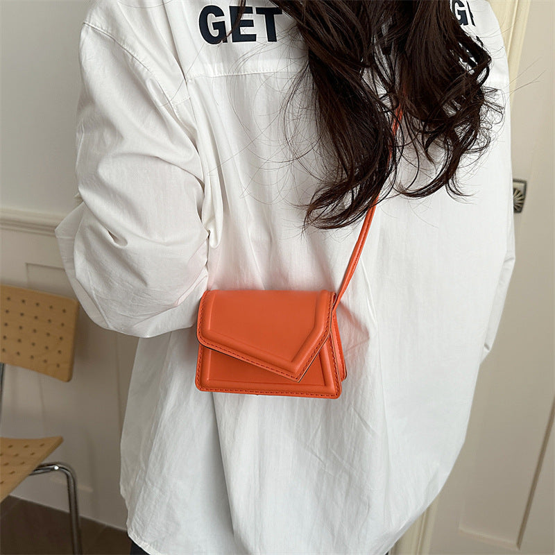 Women's mini handbag with elegant clasp closure technique