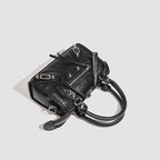 Women's mini handbag with decorative metal accents and removable shoulder strap