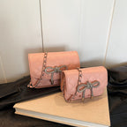 Ladies mini handbag with luxurious quilted pattern and sparkling chain pendant
