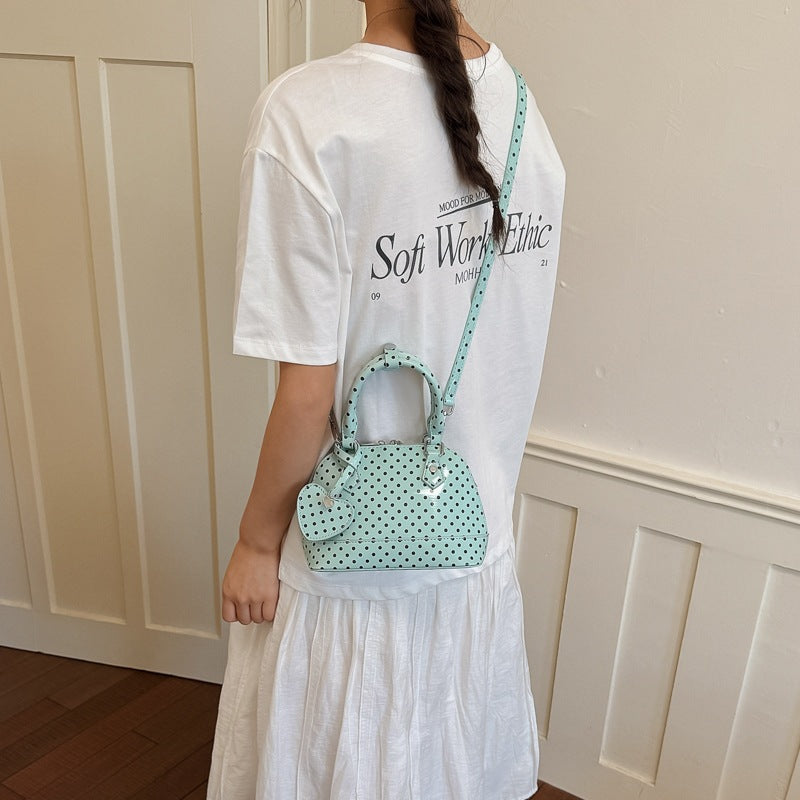 Women’s mini handbag with playful polka dot pattern and detachable shoulder strap