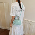 Women’s mini handbag with playful polka dot pattern and detachable shoulder strap
