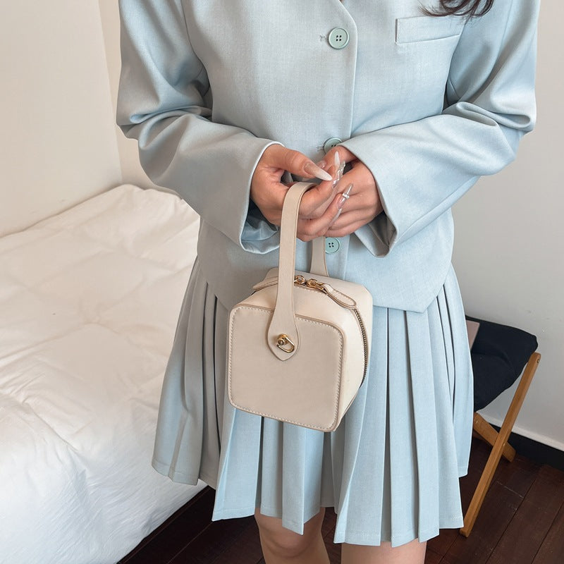 Ladies mini handbag with removable shoulder strap and elegant flap closure