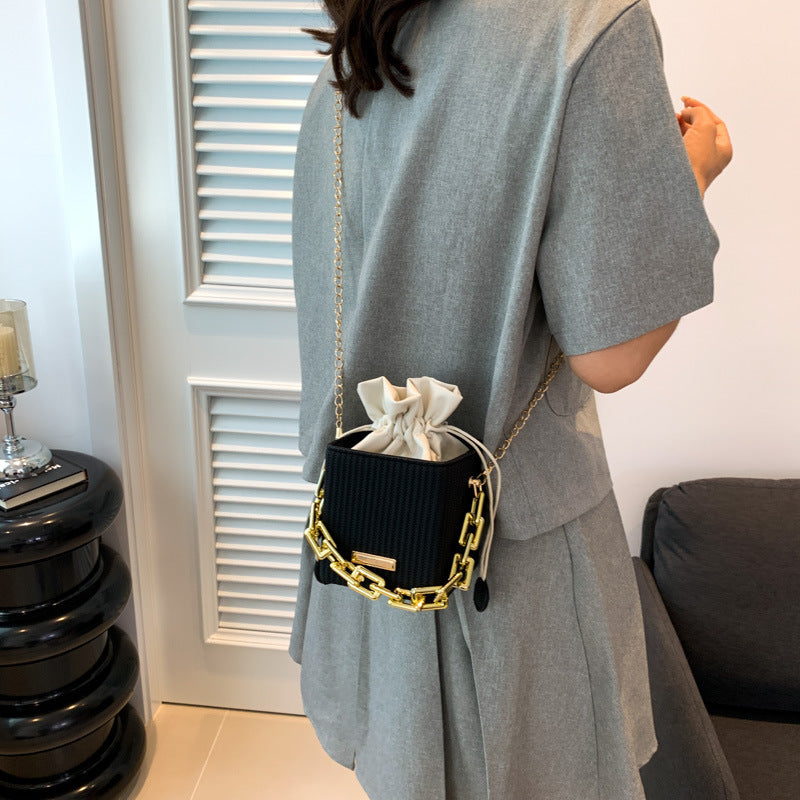 Women's mini handbag with unique chain embellishment and classic drawstring