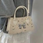 Ladies mini bag with floral woven design and stylish bow detail