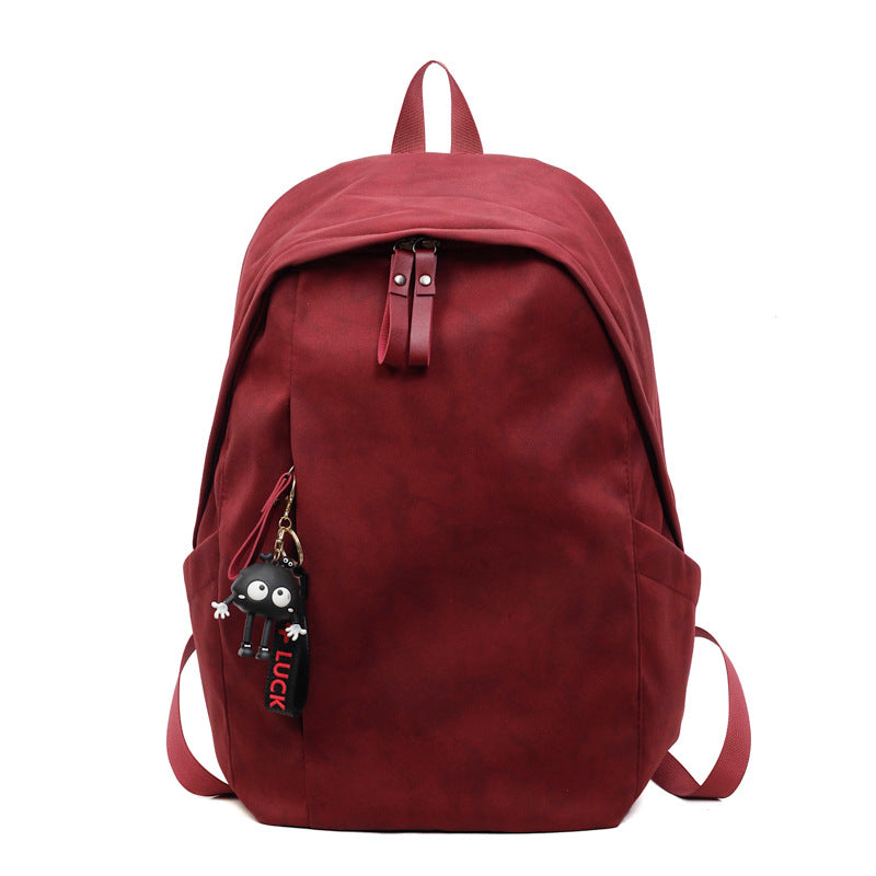 Fashionable backpack with practical design and decorative pendant