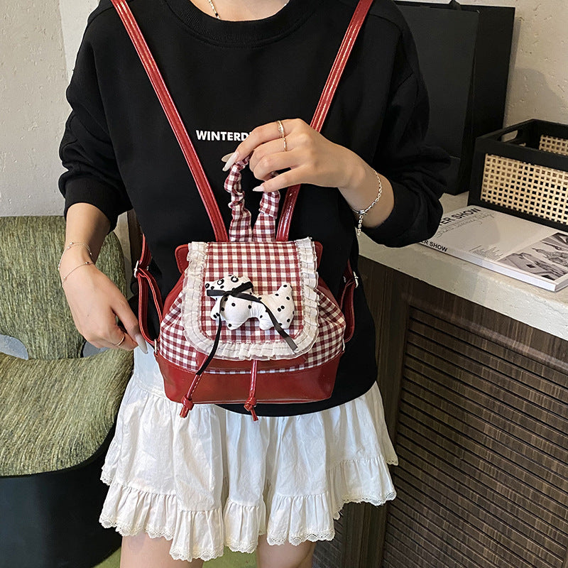 Playful backpack with checkered pattern and animal appliqué