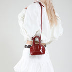 Ladies mini handbag with elegant glossy finish and removable shoulder strap