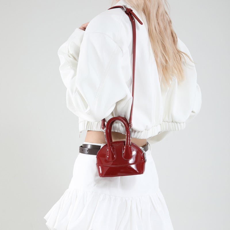 Ladies mini handbag with elegant glossy finish and removable shoulder strap