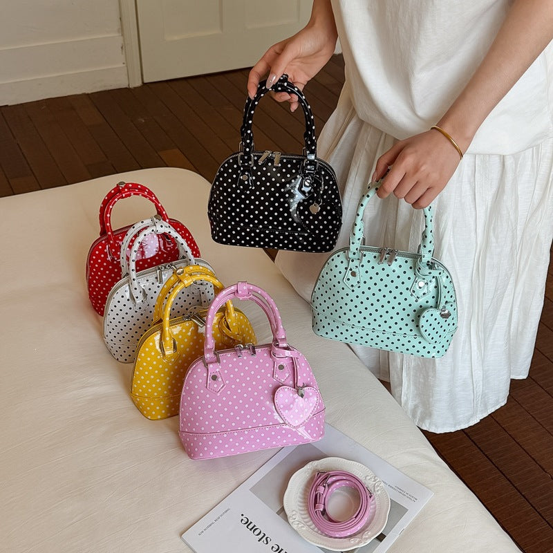 Women’s mini handbag with playful polka dot pattern and detachable shoulder strap