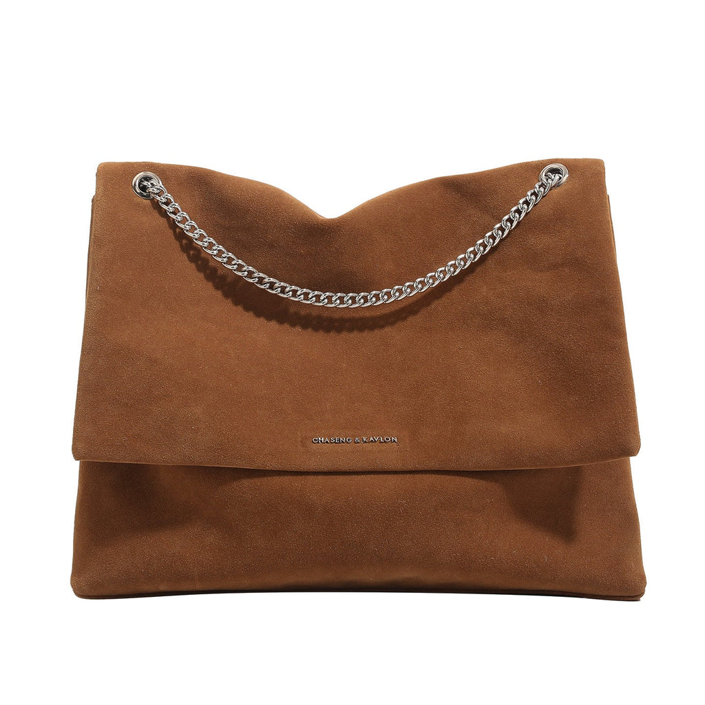 Women's clutch bag made of shiny synthetic leather with decorative chain strap