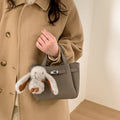 Women's mini handbag with playful design and animal charm