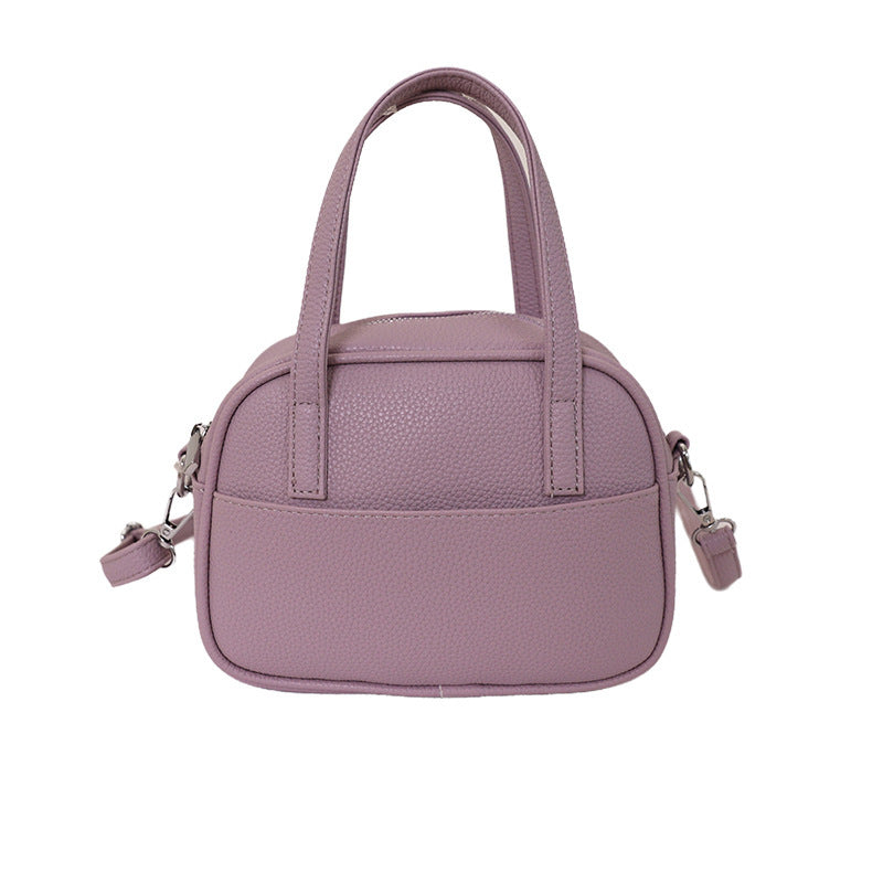 Women's mini handbag with playful animal charm