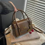 Women's mini handbag with elegant structure and charming pendant