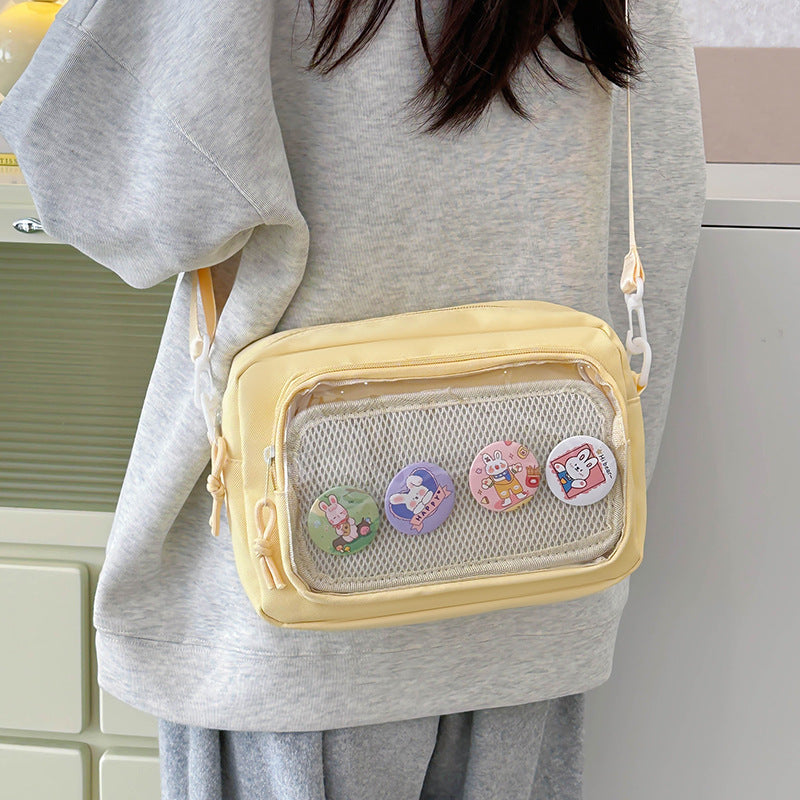 Shoulder bag with transparent viewing pocket and playful graphic design