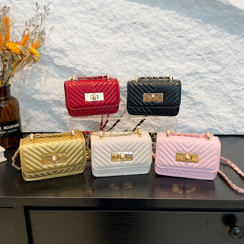 Women’s mini handbag with quilted design and golden clasp