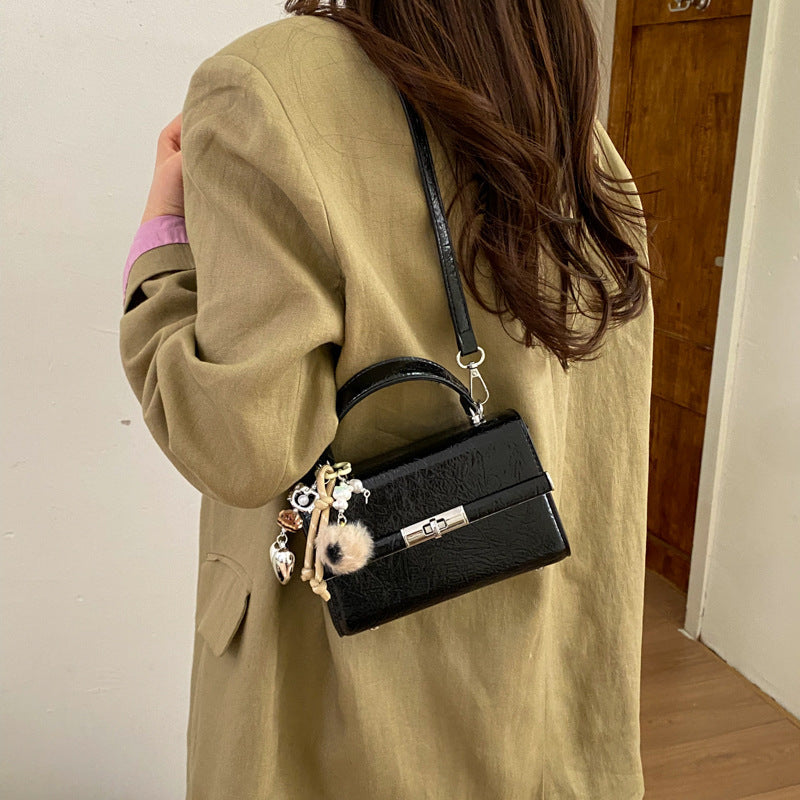 Women's mini crossbody bag with playful charm
