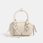 Women's mini handbag with playful drawstring and elegant accents