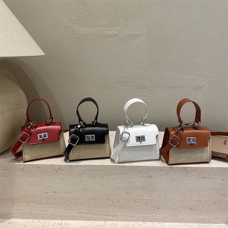 Ladies mini handbag with luxurious leather look and practical carrying handles