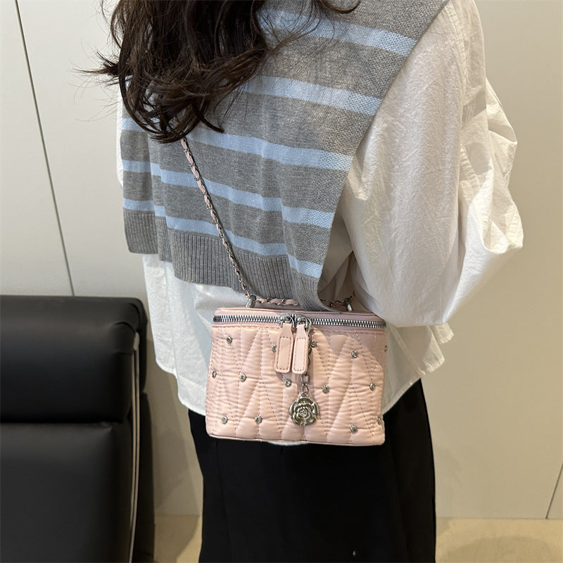 Women's mini handbag with elegant quilting and chain pendant