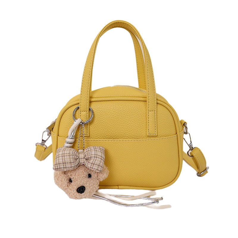 Women's mini handbag with playful animal charm