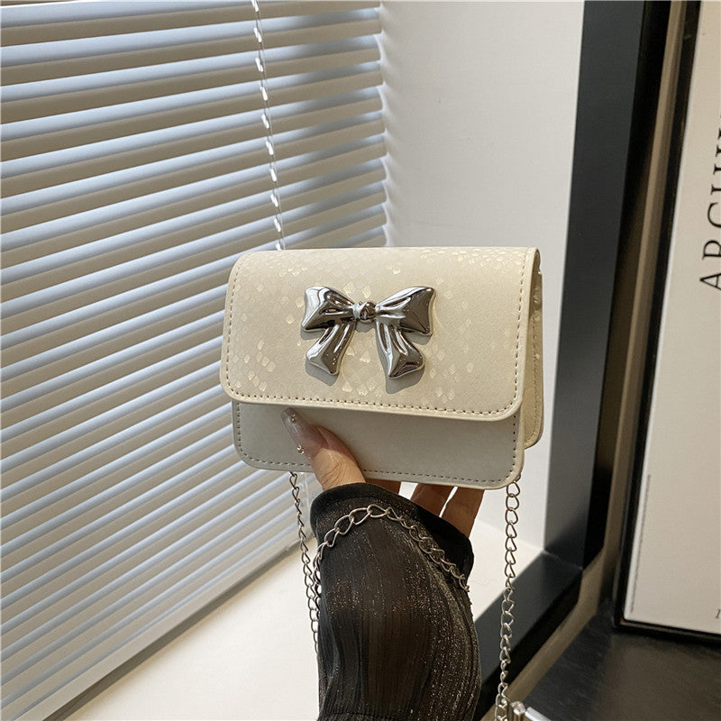 Women's clutch with playful bow design
