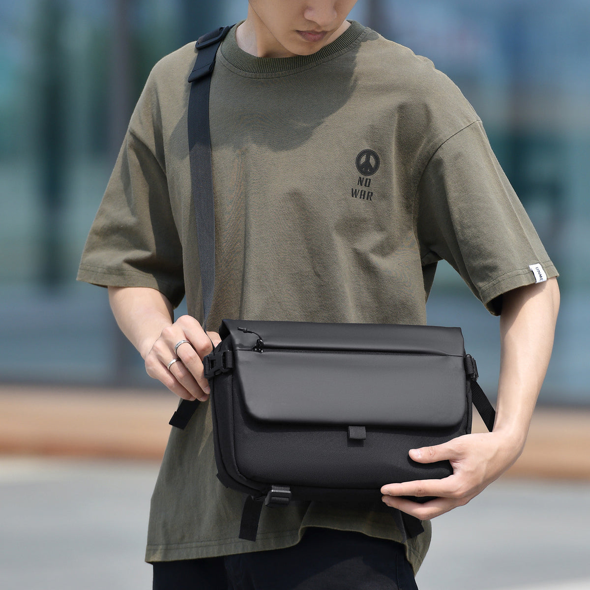 Messenger bag with versatile compartments and water-repellent material