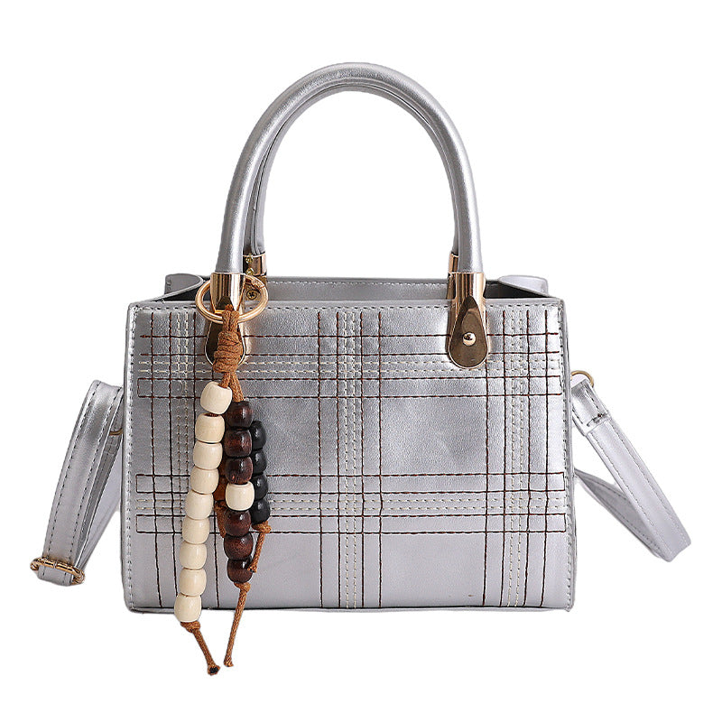 Women's mini handbag with elegant structure and golden accents