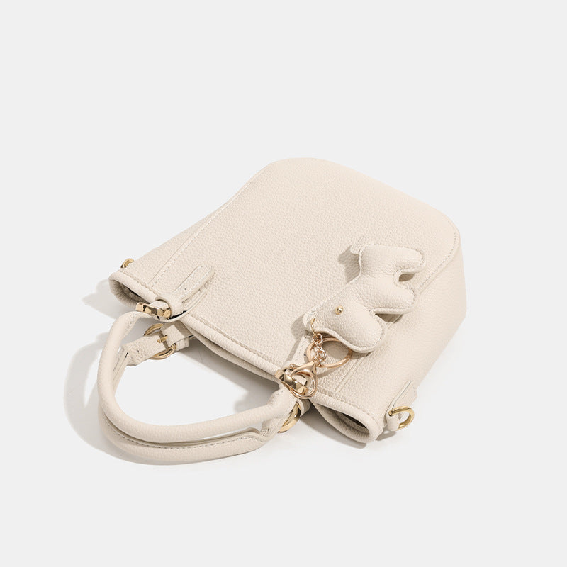 Women's mini handbag with playful animal charm