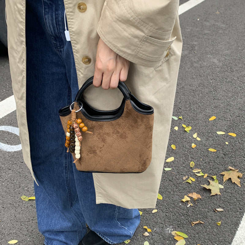 Ladies elegant handbag with high-quality suede and leather accents